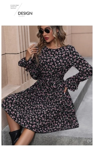 Detail of floral print on black long sleeve dress with waist tie and cuff accents
