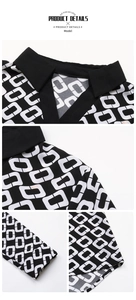 Detail view of lapel V-neckline, shoulder seams, and geometric chain print on the blouse