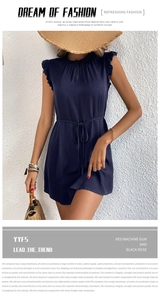 Detail of navy sleeveless summer dress with ruffled neckline and drawstring waist tie