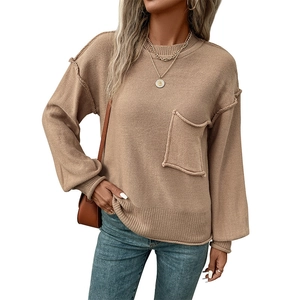 Front view of camel knit sweater with round neck, pocket detail, and ribbed cuffs