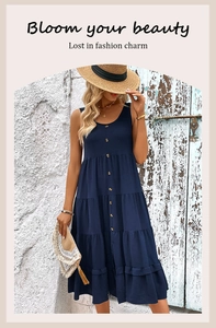 Macro shot of tiered navy blue dress with button-down front and pleated layers