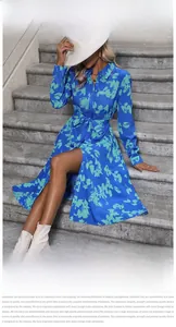 Detail of navy floral shirt dress with long sleeves, waist tie, and front button closure