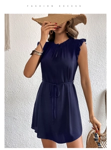 Detail of navy blue sleeveless dress featuring ruffled neckline and adjustable drawstring waist