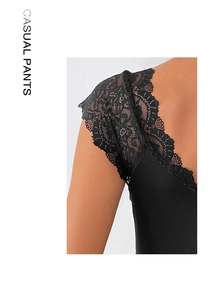 Detail of black lace patchwork on a ribbed bodysuit with V-neckline texture and stitching