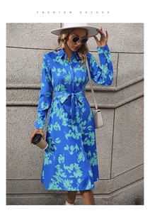 Detail of long sleeve A-line shirt dress with blue floral print and waist tie belt