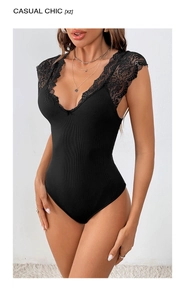 Close-up of black ribbed bodysuit featuring delicate lace patchwork and a deep V-neckline