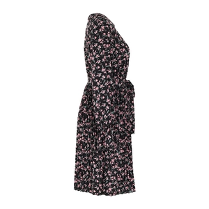 Detail showing the floral print texture, gathered cuffs, and pleated hem of the dress