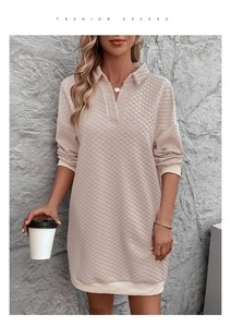 Detail of diamond quilted texture and ribbed cuffs on a beige long sleeve polo dress