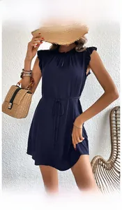 Detail of navy blue sleeveless dress featuring a ruffled collar and drawstring waist tie
