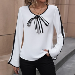 Elegant white long sleeve blouse with contrast black bow tie and piped edges