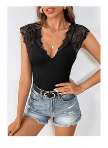 Detail view of the deep V-neck with delicate eyelash lace trim on black ribbed fabric