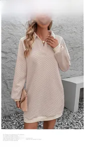 Detail shot of quilted texture and ribbed cuffs on a beige long sleeve dress