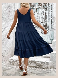Detail view of the deep blue sleeveless tiered midi dress featuring textured fabric layers