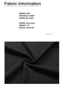 Detail view of the black ribbed fabric texture and vertical pleats of the V-neck bodysuit