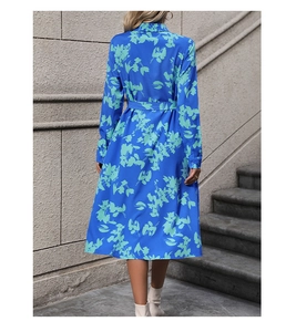 Detail of royal blue midi dress with green floral print and waist tie at the back
