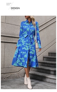 Detail of royal blue A-line shirt dress featuring floral print and tie waist belt