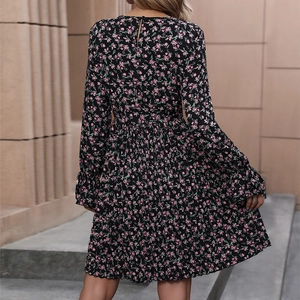 Women's floral long sleeve pleated dress in black with pink floral print and tie waist