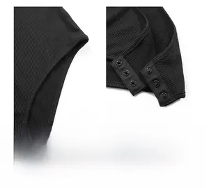 Detail view of the side seams and triple snap-button closure on black ribbed bodysuit