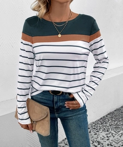 Detail of round neck striped patchwork top featuring green and brown color block accents