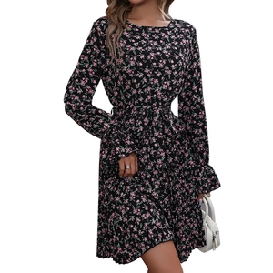 Floral long sleeve dress with pink blossoms on black fabric featuring ruffled hemline