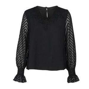Women's black long sleeve top with lace V-neckline and sheer jacquard sleeves on white background