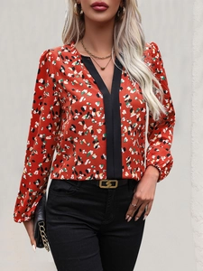Detail of V-neck blouse with colorful floral print and contrasting black trim collar