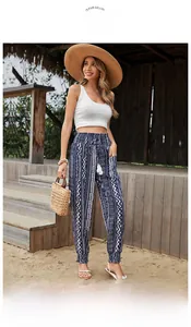 Detail of high-waist ethnic print trousers with side pockets and drawstring waist