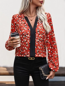 Detail of V-neckline with black trim and vibrant floral print on long sleeve shirt