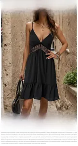 Detail view of black V-neck mini dress showing lace patchwork and dot textured fabric
