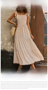 Detail of adjustable shoulder tie bows and tiered layered skirt on apricot long dress