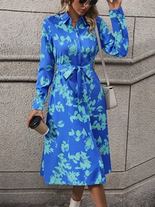 Royal blue floral print A-line shirt dress with long sleeves and a matching waist tie