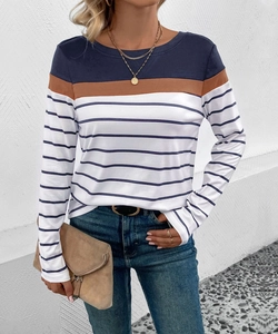 Detail of round neck long sleeve top with blue and brown striped patchwork design