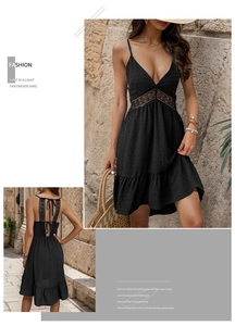 Detail of V-neck lace patchwork on black summer dress with ruffle hem and textured fabric