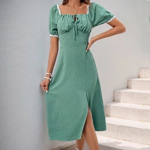 Detail of Swiss dot fabric and white lace trim on a sage green dress neckline