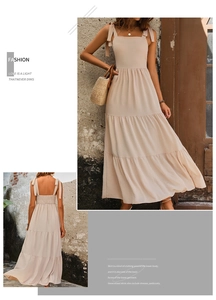 Detail of apricot tiered midi dress featuring tie-up straps and ruffled chiffon fabric