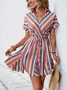 Detail of colorful striped mini dress featuring V-neckline and adjustable waist drawstring