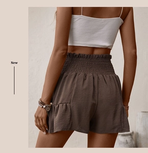 Detail of high-waisted smocked shorts with ruffle hem and back silhouette view