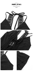 Detail view of Swiss dot fabric and intricate floral lace stitching on black V-neck dress