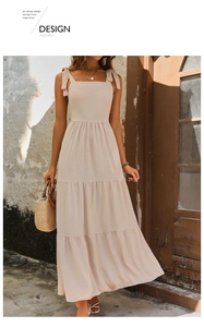 Detail view of tiered beige summer dress with stylish bow straps and a square neckline