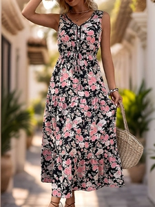 Detail of bohemian floral print maxi dress with V-neckline and layered cake skirt design