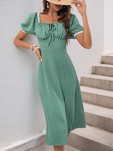 Detail of Swiss dot fabric and lace trim on a green puff sleeve square neck midi dress