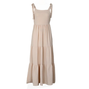 Close-up of beige tiered maxi dress featuring tie-up straps and textured cotton fabric