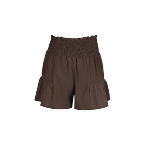 Detailed macro view of high-waist smocked waistband and ruffle hem on brown shorts
