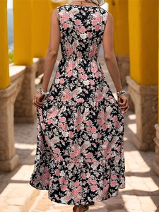 Back view of a sleeveless floral maxi dress with tiered skirt in a sunny resort setting