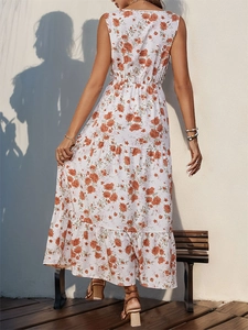 Detail of tiered sleeveless maxi dress with orange floral print and bohemian style
