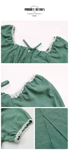 Detail view of Swiss dot texture, lace trim, and square neckline on green summer dress