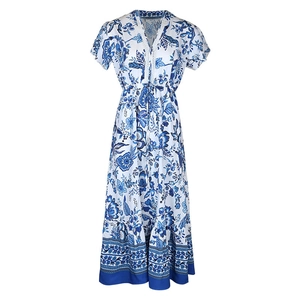 Detail of blue and white floral dress featuring V-neckline with lace trim and waist drawstring