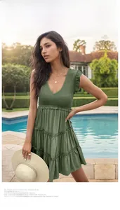 Detail of army green tiered sun dress featuring elegant ruffles and a deep V-neckline