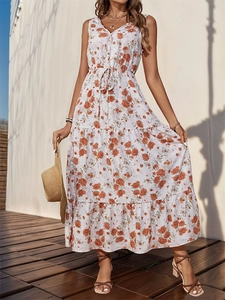 Detail of bohemian summer maxi dress featuring V-neck and orange floral print patterns