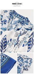 Detail of blue floral print on white dress with V-neckline and white lace crochet trim